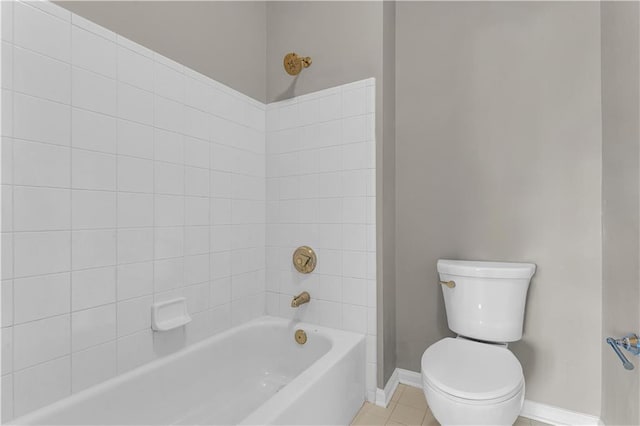 bathroom with tile patterned flooring, tiled shower / bath combo, and toilet