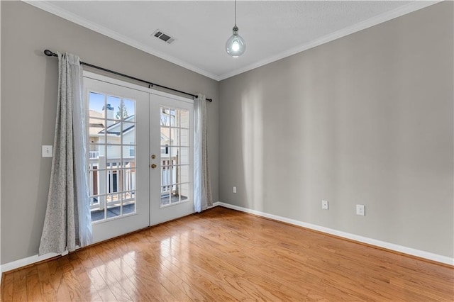 doorway with french doors, hardwood / wood-style flooring, and ornamental molding