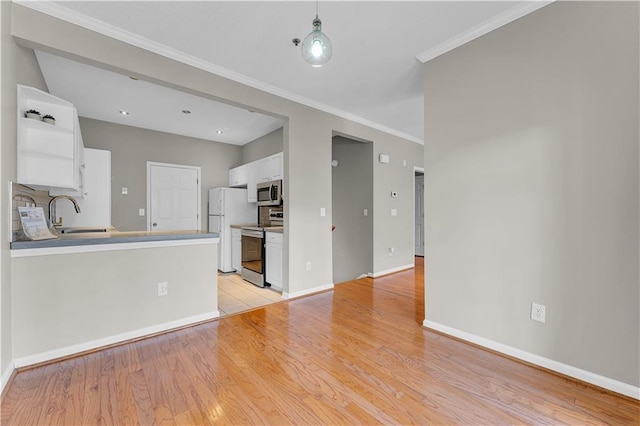 kitchen featuring tasteful backsplash, sink, white cabinets, and stainless steel appliances