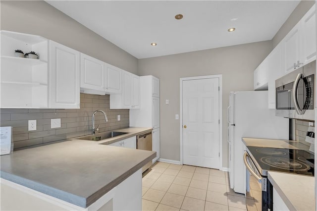 kitchen with kitchen peninsula, stainless steel appliances, sink, light tile patterned floors, and white cabinets