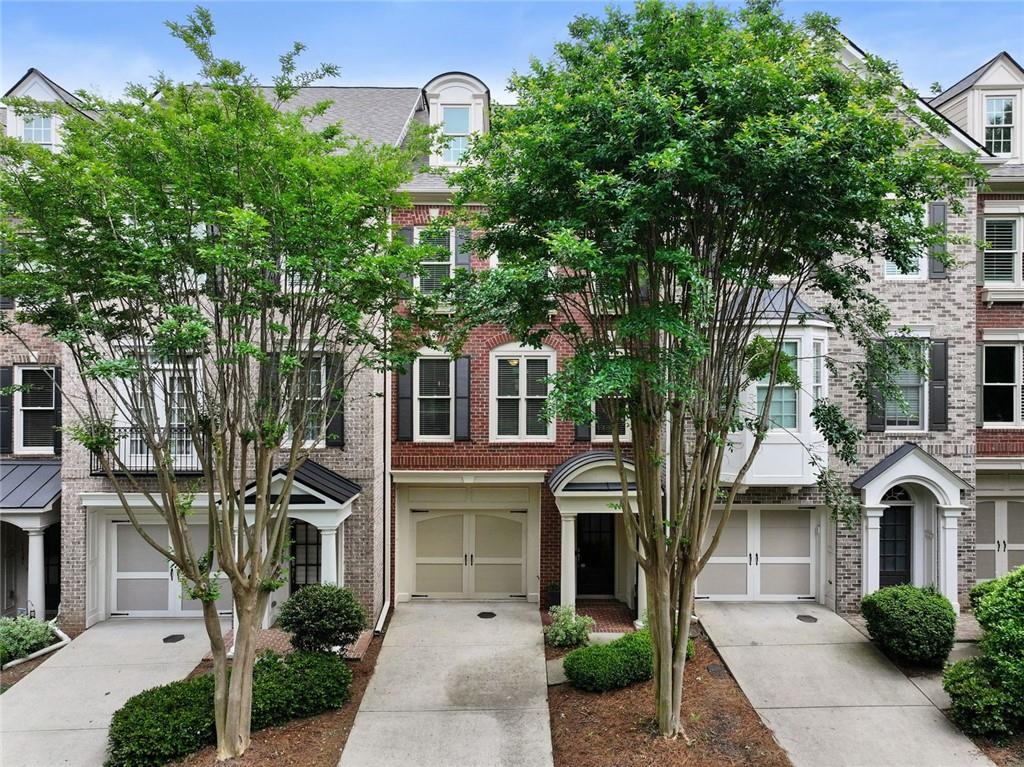 11187 Calypso Dr Unit 12, Alpharetta, GA 30009 - view of property with brick siding, driveway, and a garage