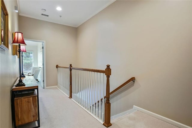 staircase with baseboards, ornamental molding, carpet, and visible vents