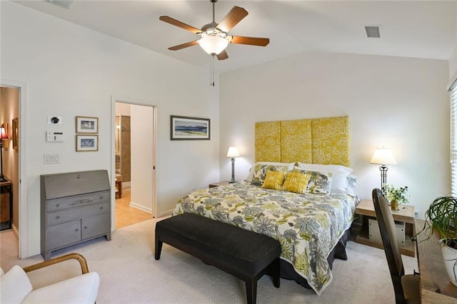 bedroom with visible vents, light carpet, ensuite bathroom, ceiling fan, and vaulted ceiling