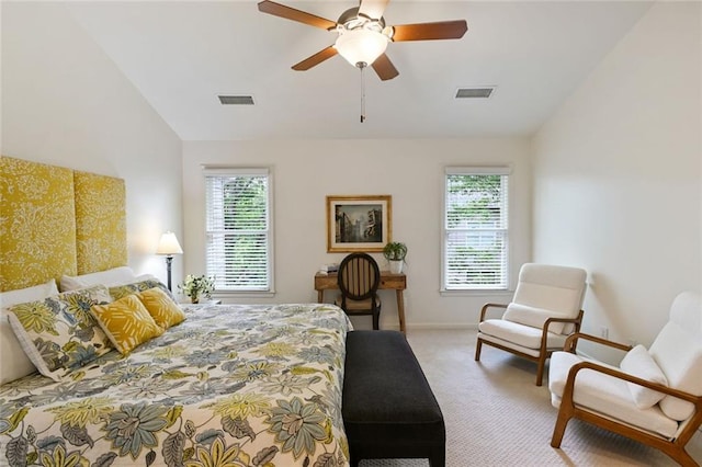 carpeted bedroom featuring visible vents, lofted ceiling, and multiple windows