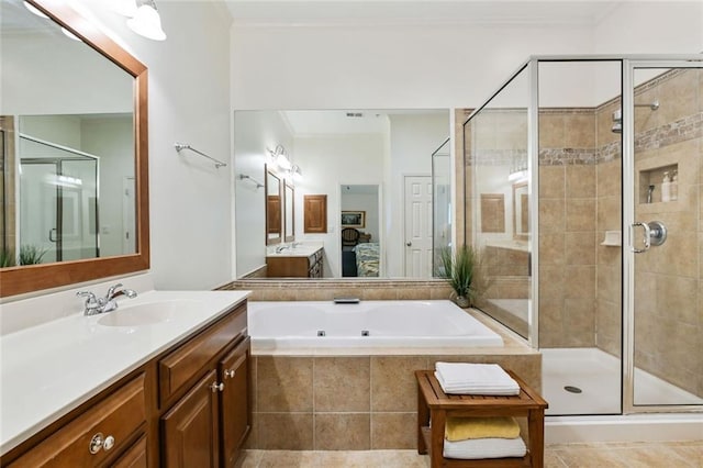 full bathroom featuring ensuite bath, vanity, a shower stall, ornamental molding, and a garden tub