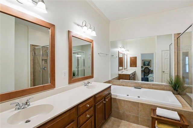 bathroom with a garden tub, a sink, double vanity, and a shower stall