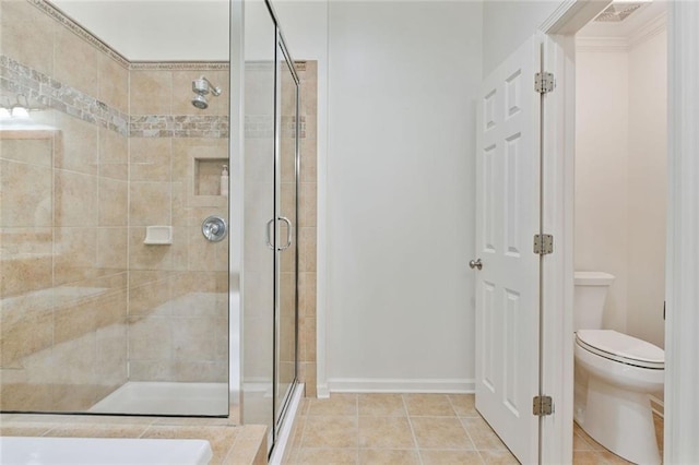 full bath featuring toilet, tile patterned floors, visible vents, and a shower stall