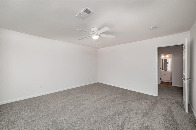 empty room with a ceiling fan, baseboards, visible vents, and carpet flooring