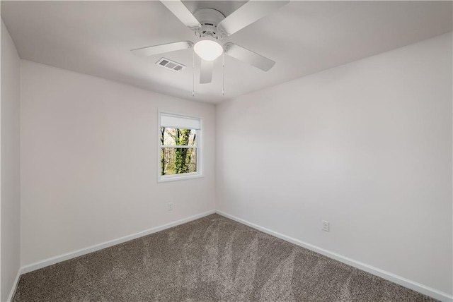 carpeted spare room with ceiling fan, visible vents, and baseboards