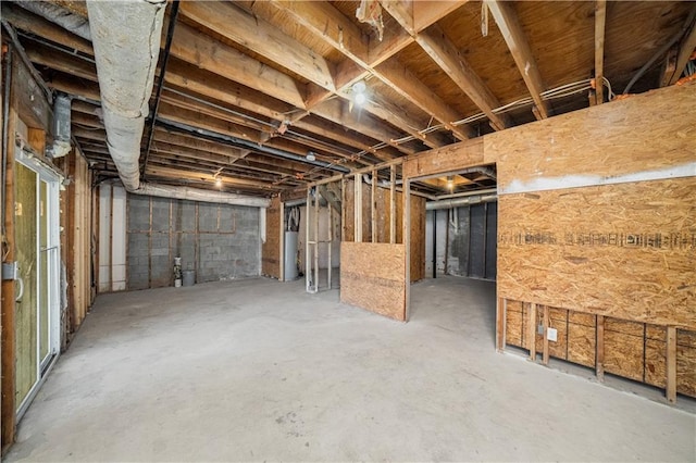 unfinished basement featuring water heater