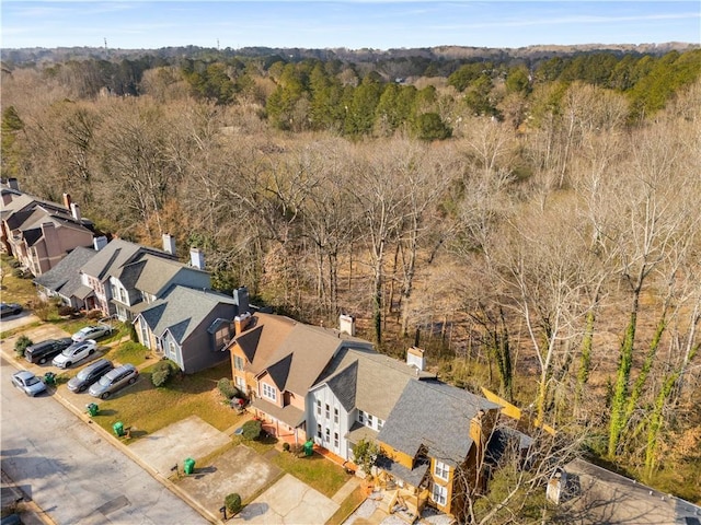 bird's eye view with a wooded view