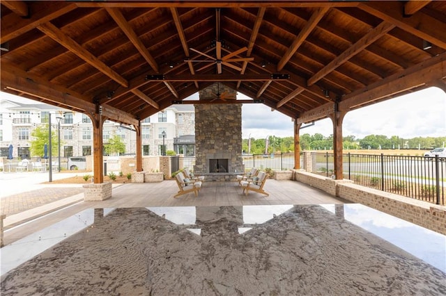 view of patio featuring a gazebo and an outdoor stone fireplace