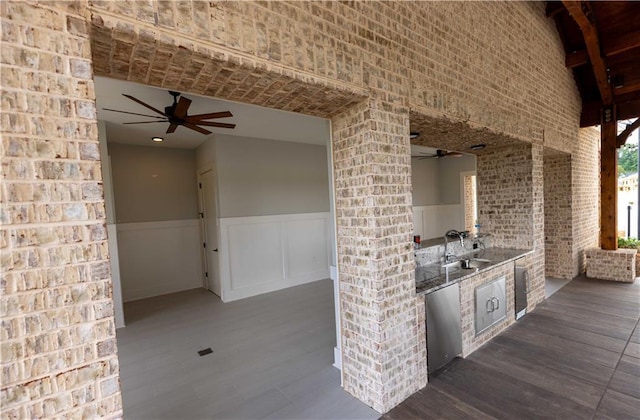 view of patio / terrace featuring an outdoor kitchen, ceiling fan, and sink