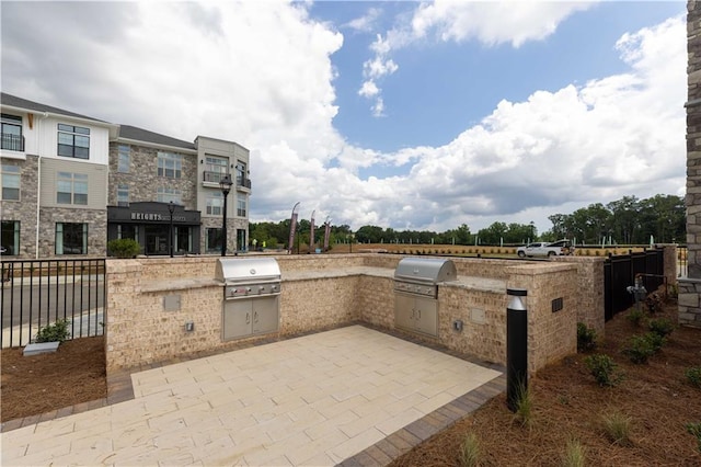 view of patio / terrace featuring a grill and an outdoor kitchen