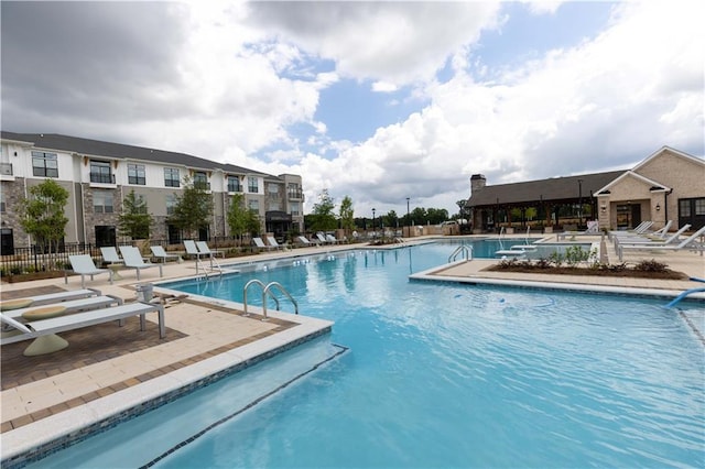 view of swimming pool featuring a patio area