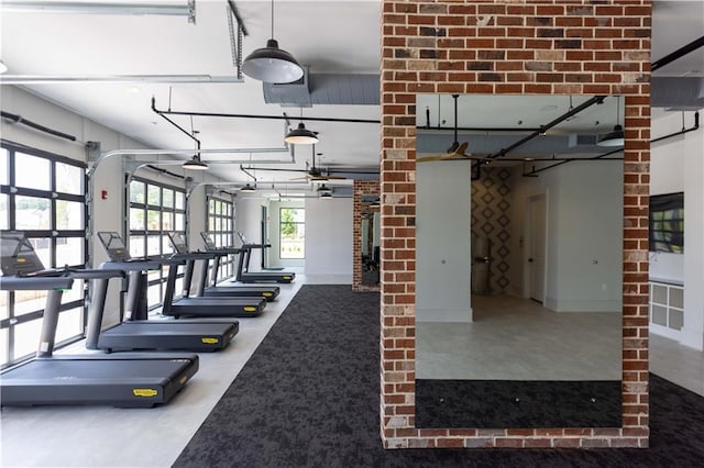 exercise room featuring brick wall