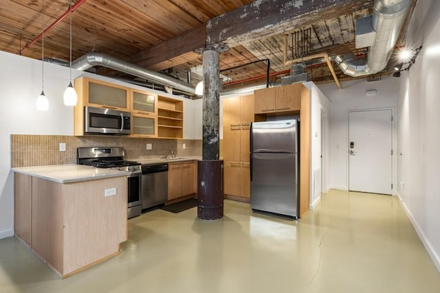 kitchen featuring stainless steel appliances, a peninsula, concrete flooring, and backsplash