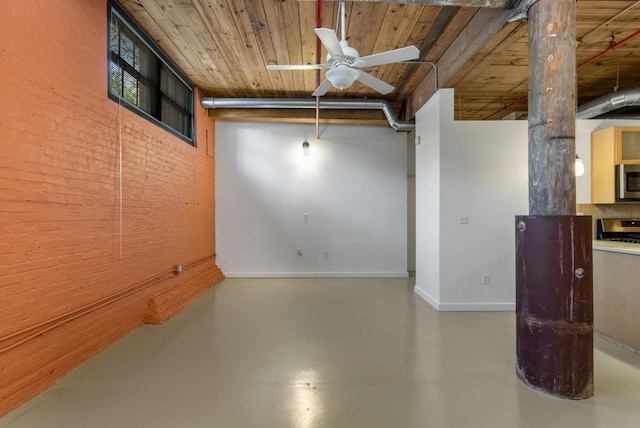 spare room with baseboards, wooden ceiling, concrete flooring, and ceiling fan