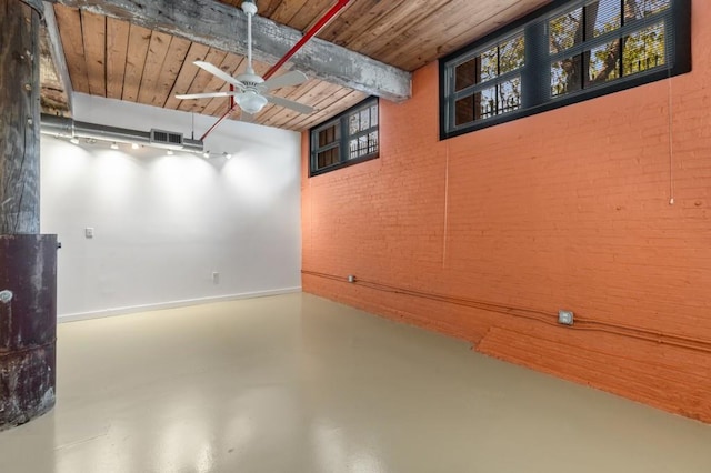 below grade area with ceiling fan, visible vents, wooden ceiling, and brick wall