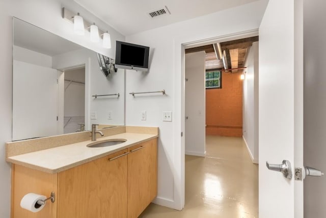 bathroom featuring baseboards, vanity, and visible vents