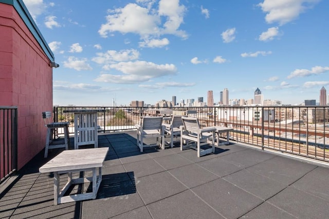view of patio featuring a view of city and a balcony