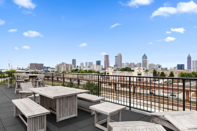 view of patio / terrace with a balcony and a view of city