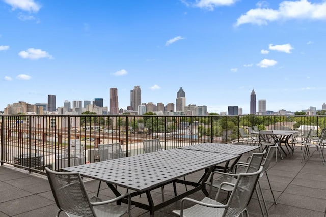 view of patio / terrace with a view of city and outdoor dining area