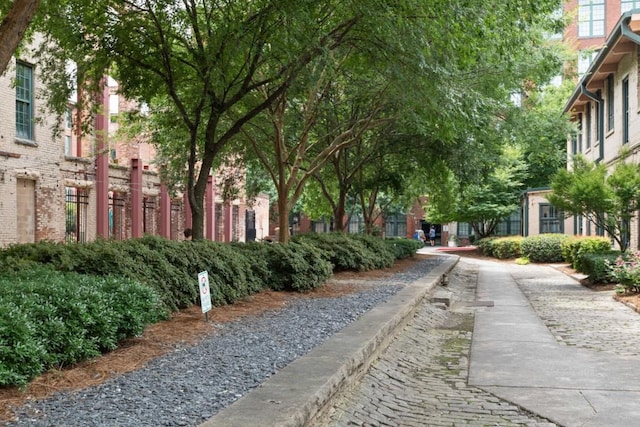 view of home's community featuring fence