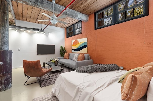 bedroom featuring visible vents, beamed ceiling, wood ceiling, finished concrete floors, and brick wall