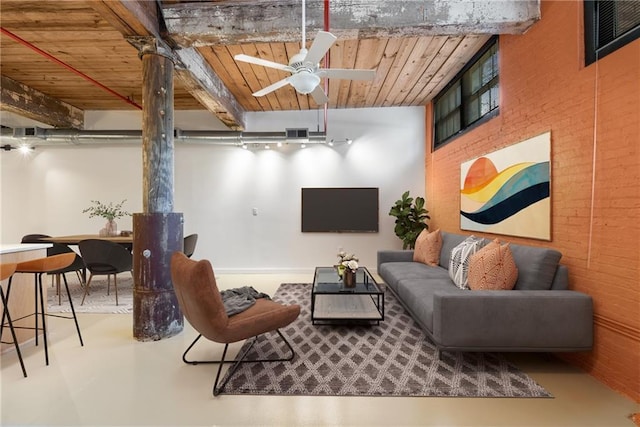 interior space featuring visible vents, a ceiling fan, concrete floors, wooden ceiling, and a wood stove