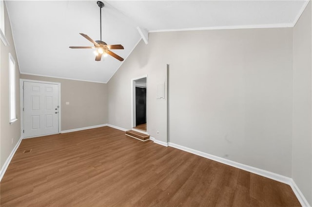 interior space featuring wood finished floors, vaulted ceiling with beams, a ceiling fan, and baseboards