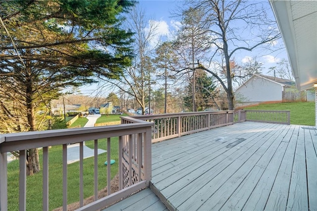 wooden terrace featuring a yard