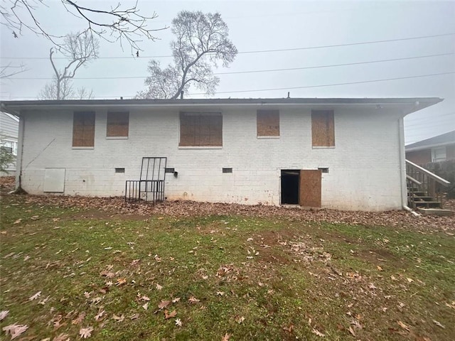 rear view of house with a yard