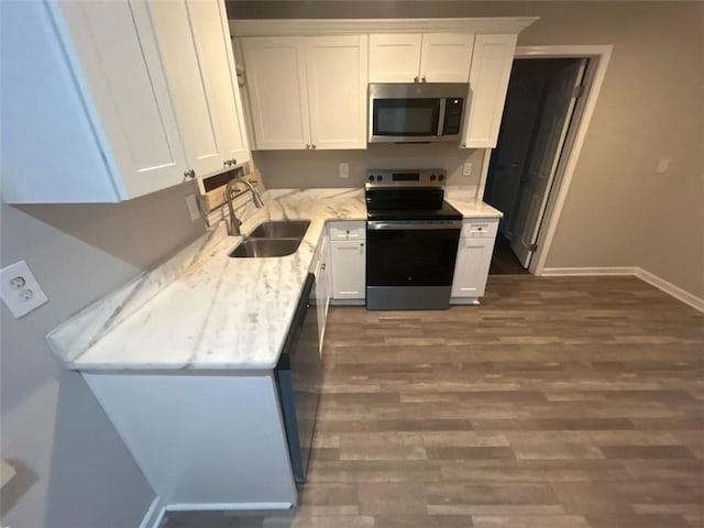 kitchen featuring sink, white cabinets, dark wood-type flooring, and appliances with stainless steel finishes