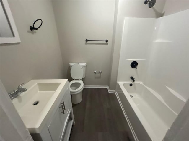 full bathroom featuring hardwood / wood-style flooring, vanity,  shower combination, and toilet