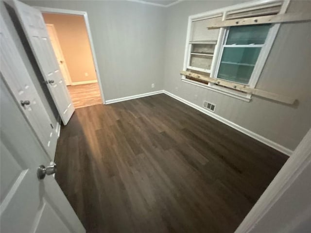 unfurnished room featuring dark wood-type flooring