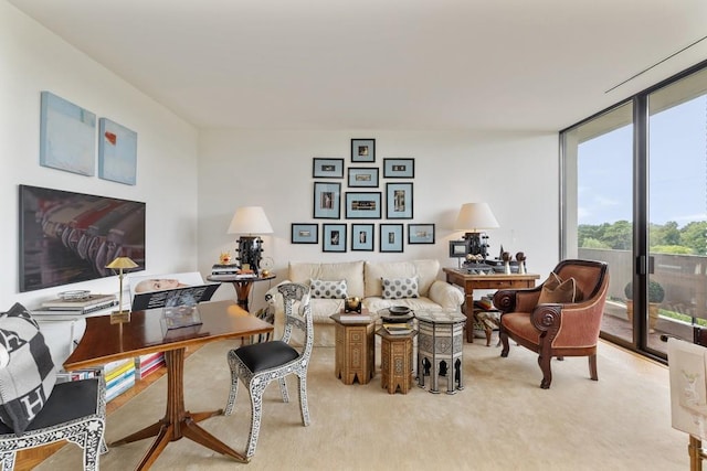 living room with a wall of windows and light colored carpet