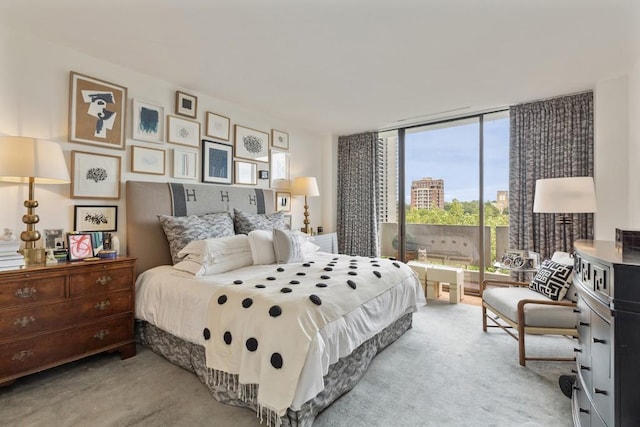 carpeted bedroom with a wall of windows and access to outside