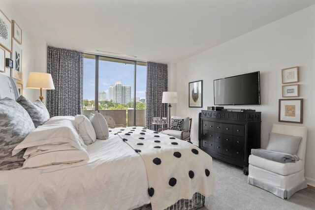 carpeted bedroom featuring floor to ceiling windows