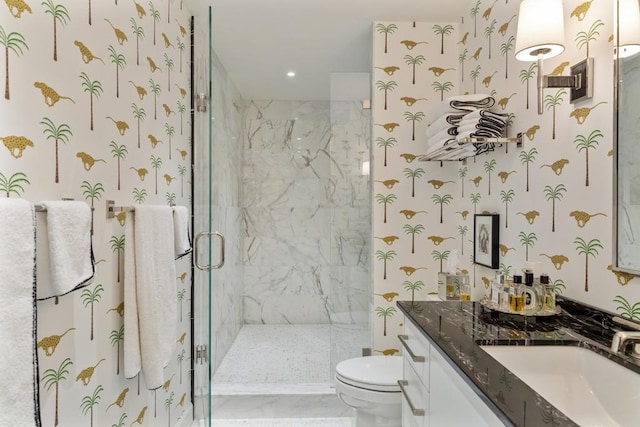 bathroom with an enclosed shower, vanity, and toilet