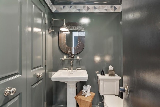 bathroom featuring sink and toilet