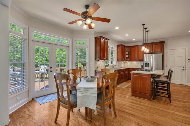 dining area featuring recessed lighting, light wood-style floors, ornamental molding, ceiling fan, and french doors