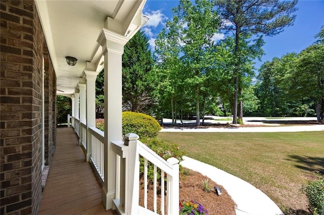 exterior space featuring covered porch and view of wooded area
