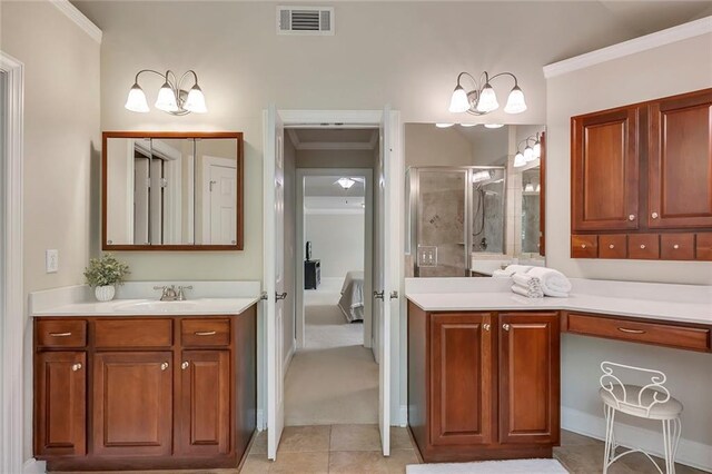 ensuite bathroom featuring a chandelier, a shower stall, tile patterned flooring, vanity, and crown molding