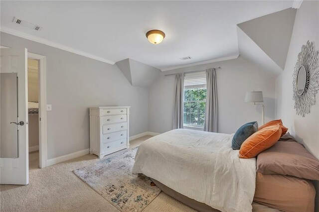 carpeted bedroom with lofted ceiling, baseboards, and ornamental molding