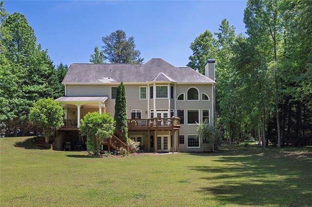 back of property with french doors, stairs, a lawn, and a chimney
