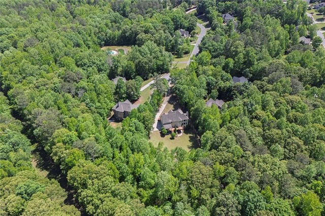 view of property location with a forest