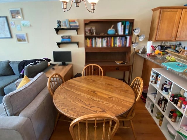 dining space featuring a notable chandelier and dark wood-type flooring