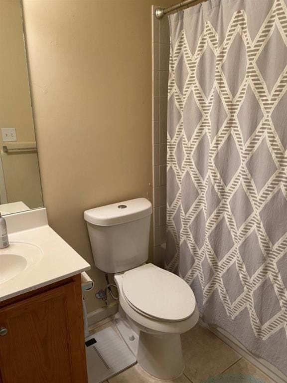 bathroom with toilet, tile patterned flooring, vanity, and a shower with shower curtain