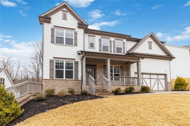 craftsman inspired home with a garage, a front lawn, and covered porch